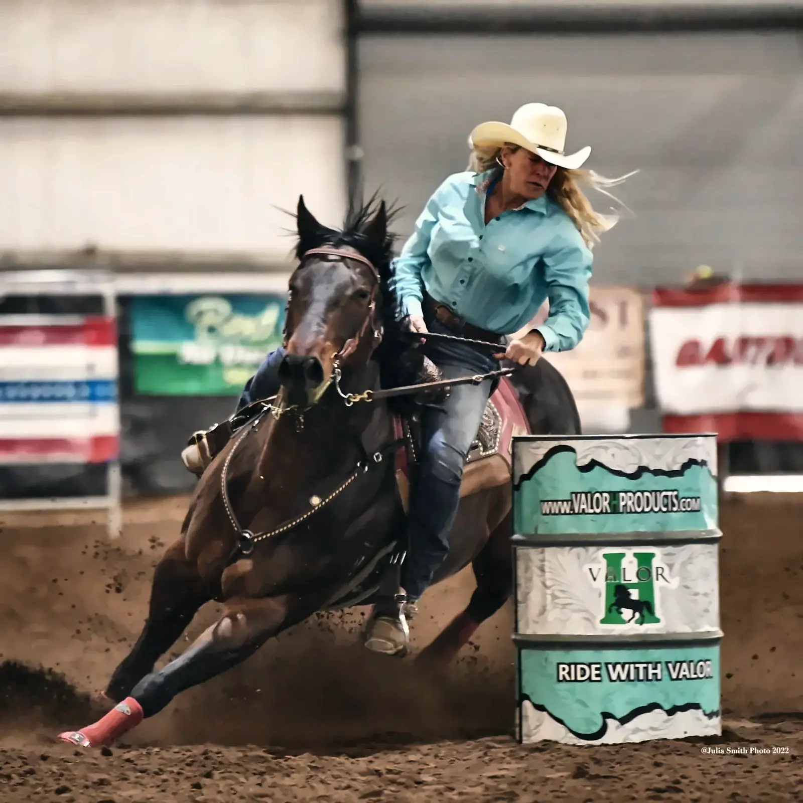 Tanya Ledbetter rounding a barrel in a turquoise shirt